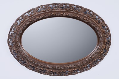 Lot 146 - A Victorian carved bronzed hardwood and gesso wall mirror