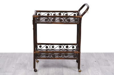 Lot 58 - An early 20th Century stained bamboo two tier tea trolley