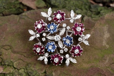 Lot 516 - Manner of Cartier: a mid-20th Century ruby, sapphire and diamond floral brooch