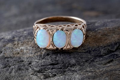 Lot 240 - A three-stone opal cabochon ring