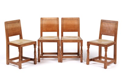 Lot 1073 - Robert ‘Mouseman’ Thompson: a set of four oak panel back dining chairs