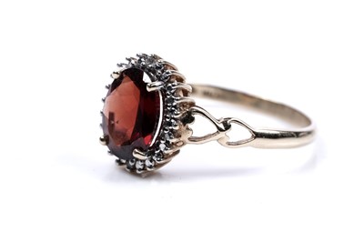 Lot 231 - A garnet and diamond cluster ring