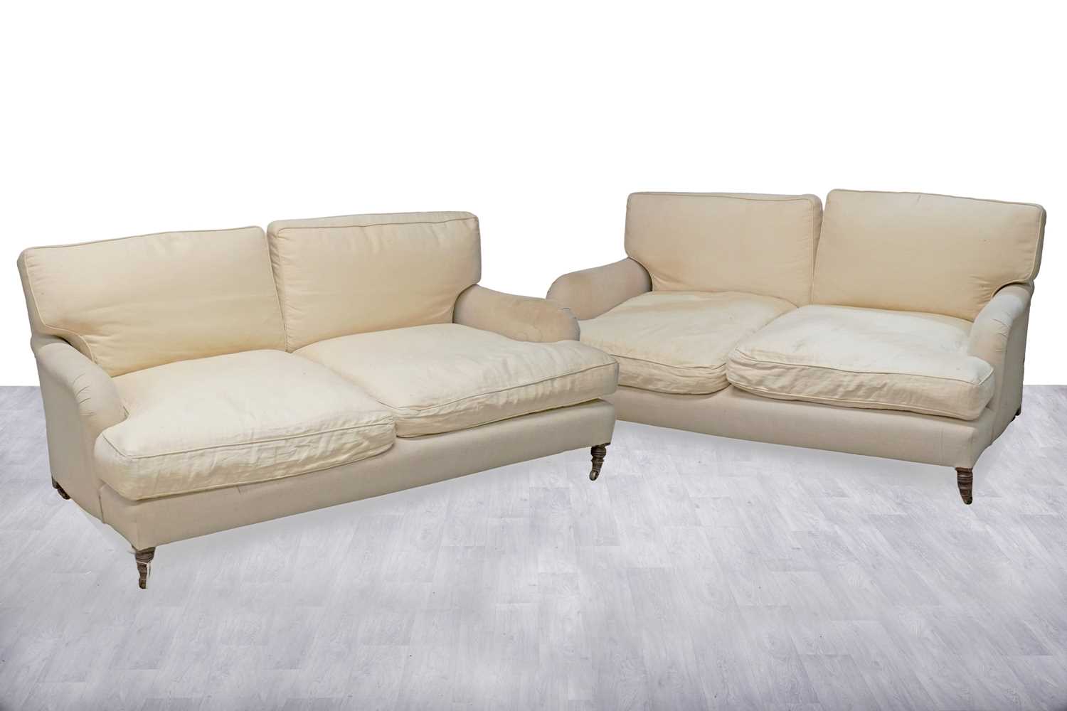 Lot 2 - In the style of Howard & Sons: a pair of substantial sofas