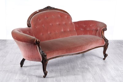 Lot 60 - A Victorian walnut serpentine-fronted button back sofa