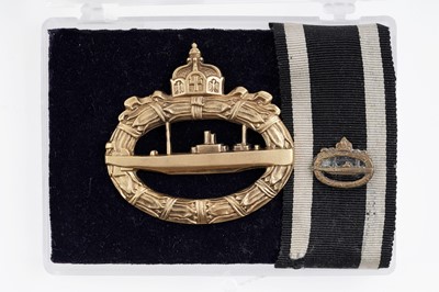 Lot 815 - A German First World War U-Boat War badge and miniature badge on ribbon
