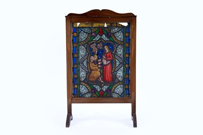 Lot 204 - An early 20th Century mahogany and stained-glass fire screen