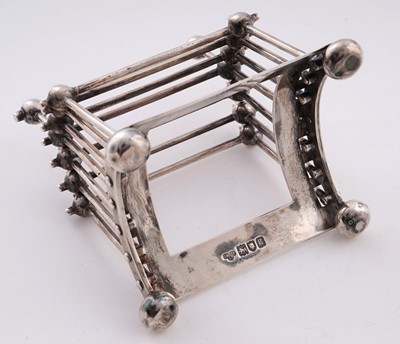 Lot 168 - An Edwardian arts and crafts silver toast rack