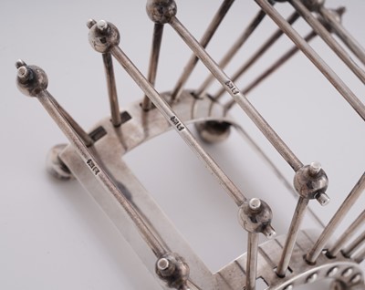 Lot 168 - An Edwardian arts and crafts silver toast rack