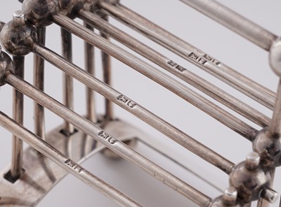 Lot 168 - An Edwardian arts and crafts silver toast rack