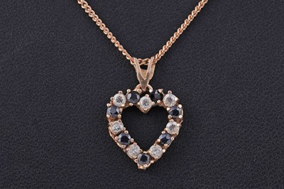 Lot 128 - A blue sapphire love heart pattern pendant on chain
