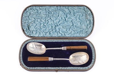 Lot 497 - A Victorian cased pair of silver serving spoons influenced by the Aesthetic Movement