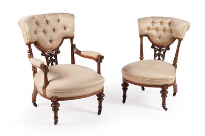 Lot 606 - A pair of Victorian walnut ladies and gentlemen’s chairs