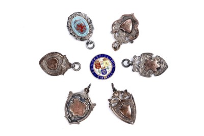 Lot 23 - Six silver fob medallions; and a Victorian silver champleve enamelled shilling