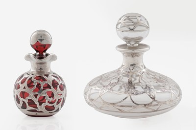 Lot 726 - A small Edwardian ruby glass globular scent bottle and stopper; and a larger clear glass example