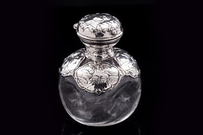 Lot 605 - An Edwardian Art Nouveau silver mounted clear glass toilet water bottle