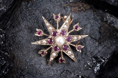 Lot 43 - An Edwardian-style ruby and pearl star pattern brooch