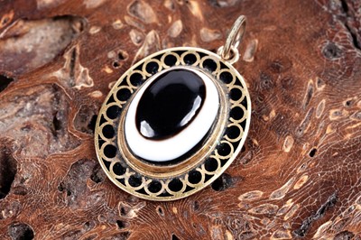 Lot 554 - A bull's-eye agate and cloisonne enamelled pendant