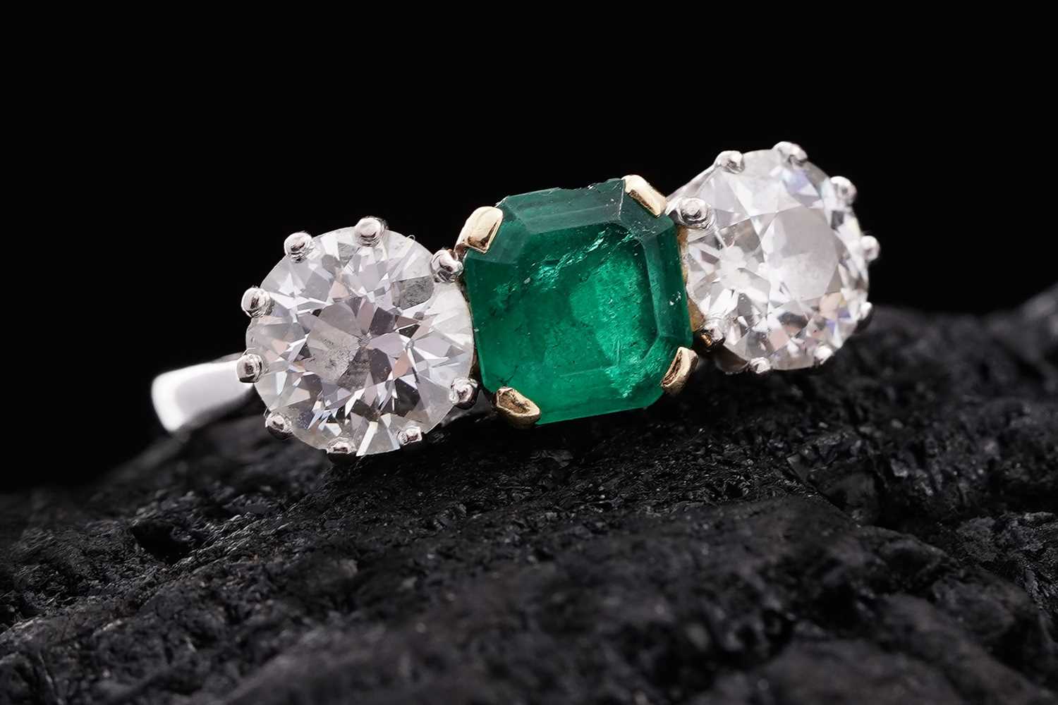 Lot 685 - A three stone emerald and diamond ring