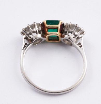 Lot 685 - A three stone emerald and diamond ring