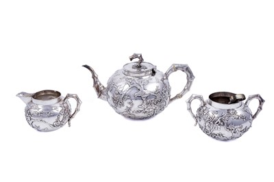 Lot 160 - A late 19th Century Chinese silver three-piece tea service; and a pair of silver sugar tongs