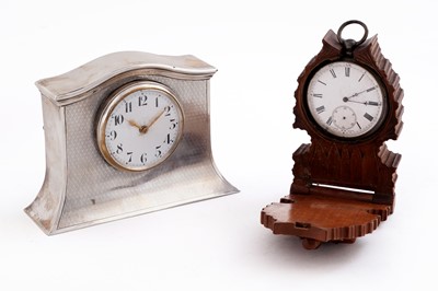 Lot 582 - A George V silver dressing table clock; and a pocket watch in stand