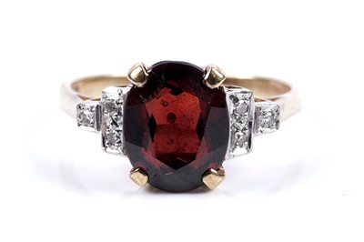 Lot 72 - A modern Art Deco style garnet and diamond ring