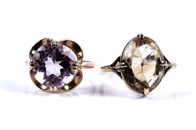 Lot 74 - Quartz dress rings: one set with citrine, the other amethyst