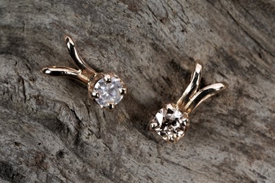 Lot 549 - Two solitaire diamond pendants