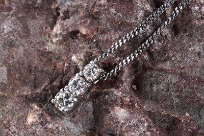 Lot 212 - A three stone diamond pendant necklace