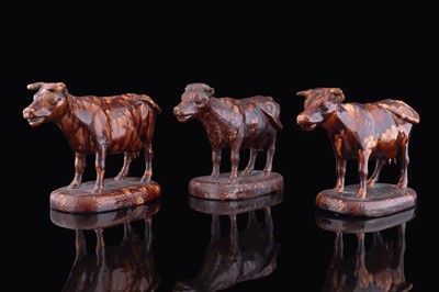 Lot 214 - Three treacle glazed cows