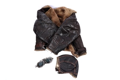 Lot 129 - A British Second World War pilot's leather and wool jacket, head cap and goggles