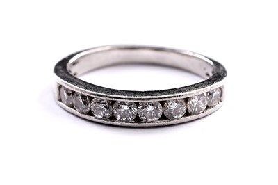 Lot 701 - A diamond half-hoop eternity ring