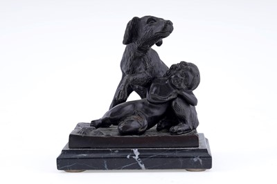 Lot 209 - A bronzed statue of a boy lying on a dog
