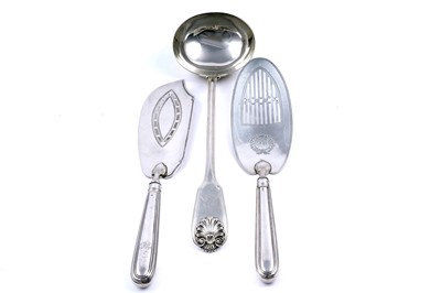 Lot 281 - Two George III silver fish slices; and a William IV silver soup ladle, William Chawner(II)