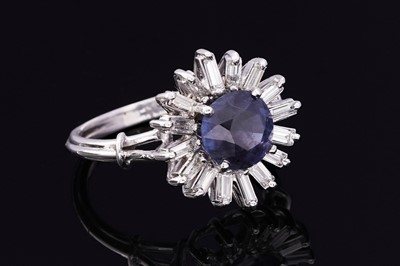 Lot 705 - A sapphire and diamond cluster ring