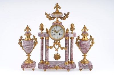 Lot 162 - Comptoir General Schnerb: red onyx and gilt metal mantel clock; and garnitures