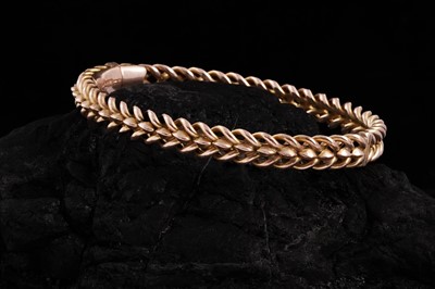Lot 286 - An Edwardian 9ct rose gold hinged bangle