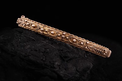 Lot 287 - A late 19th Century Etruscan inspired 9ct rose gold bangle