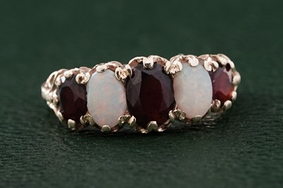 Lot 321 - A Victorian style opal and garnet ring