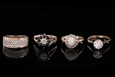 Lot 323 - Four gold rings including: a diamond and sapphire flowerhead pattern ring; and an opal ring