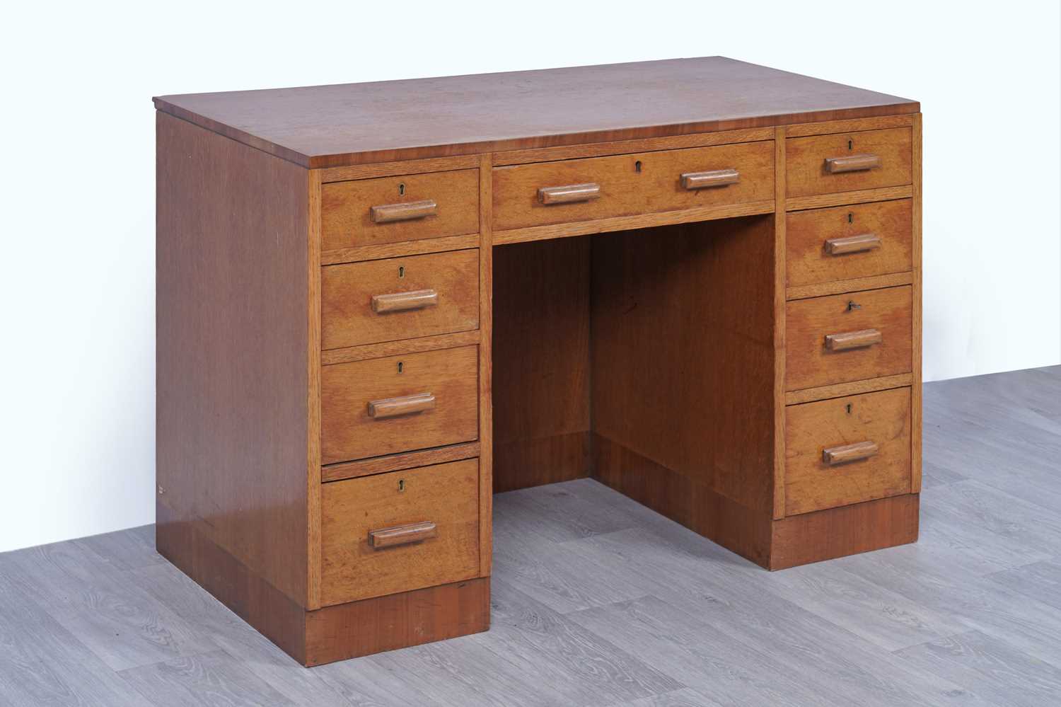 Lot 38 - An early 20th Century Art Deco oak kneehole desk