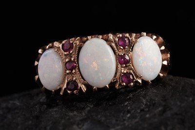 Lot 240 - A three-stone opal and ruby ring
