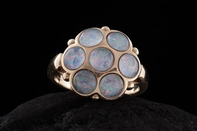 Lot 250 - A contemporary Gilson opal flowerhead pattern ring