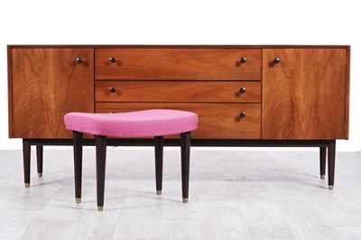Lot 95 - E Gomme for G Plan: a walnut sideboard and a stool