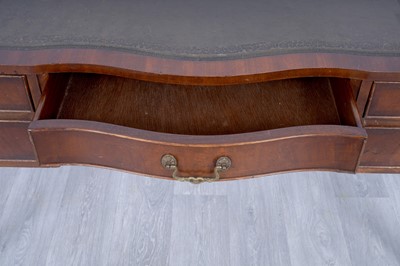 Lot 19 - A Georgian-style serpentine-fronted writing desk