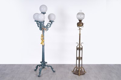 Lot 108 - A late 19th/early 20th Century Art Nouveau brass standard oil lamp; and a three branch lamp