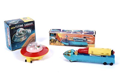 Lot 335 - A JR21 Toys "Battery Operated New Flying Saucer"; and a JR21 Toys "Space Rocket on Launching Truck"