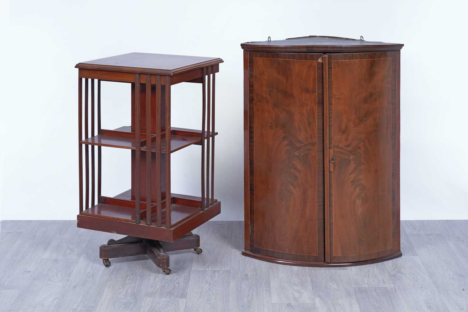 Lot 42 - An Edwardian revolving bookcase; and a Georgian inlaid mahogany corner cabinet