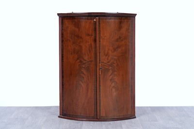 Lot 42 - An Edwardian revolving bookcase; and a Georgian inlaid mahogany corner cabinet
