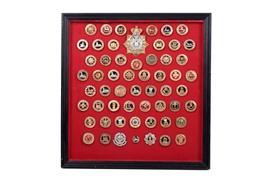 Lot 181 - A display of British Regimental helmet plates and centres